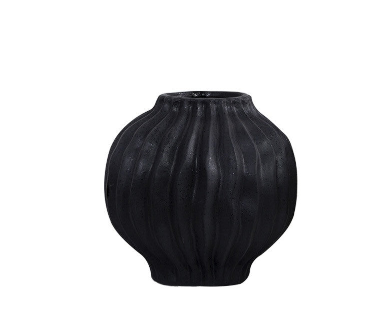 Close up detail of black matte ceramic vase with ribbed texture