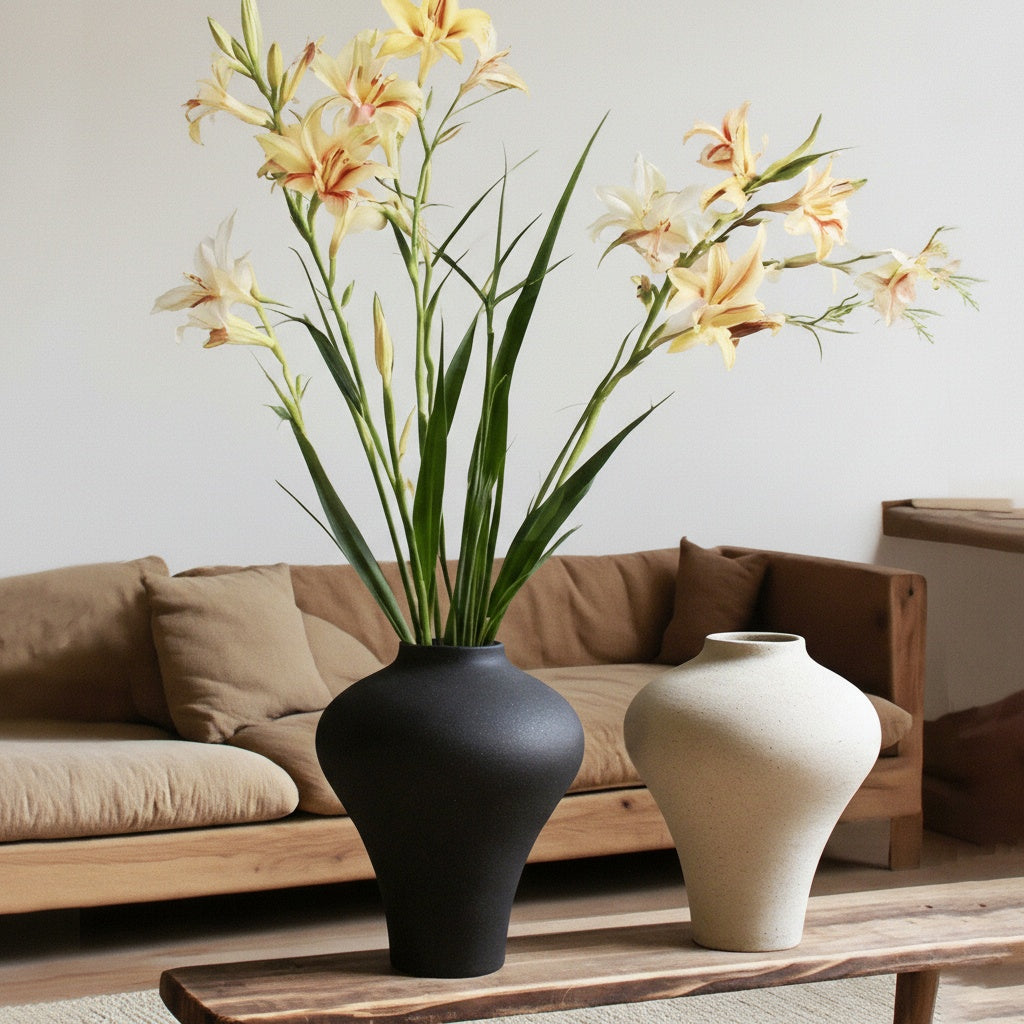 Black speckled ceramic vase with yellow flowers on wooden table
