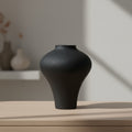 Close up of black matte ceramic vase isolated on white background