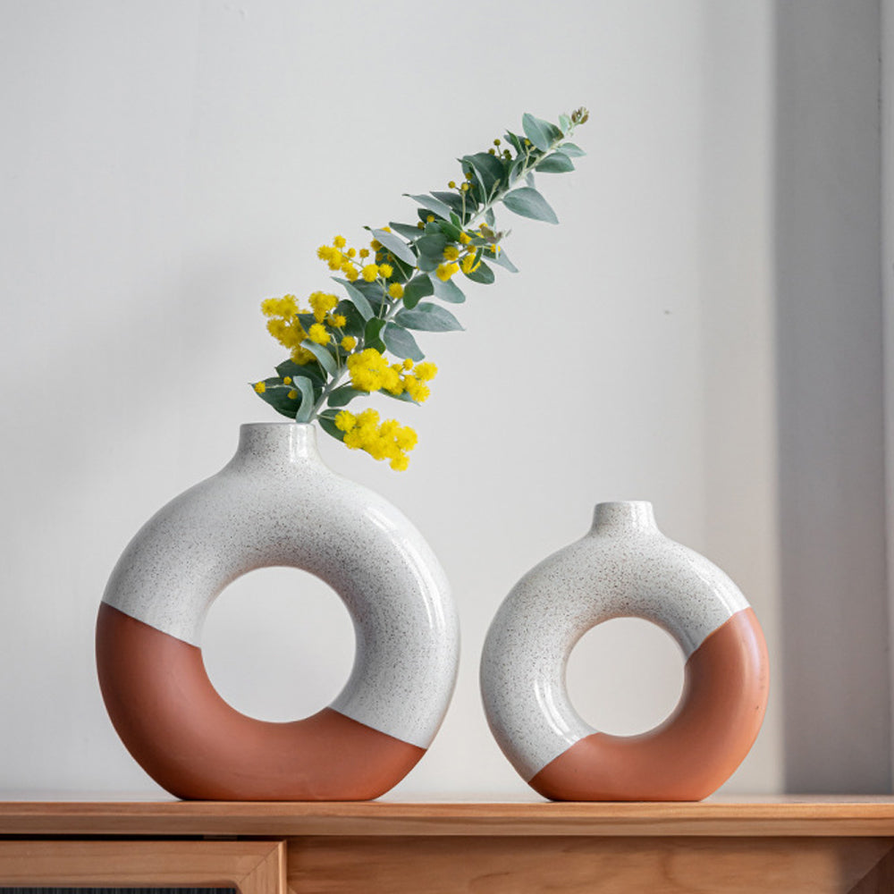 Two tone ceramic donut vases styled with yellow flowers