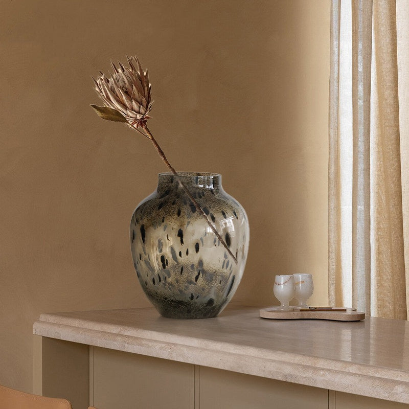 Black speckled glass vase with dried flower