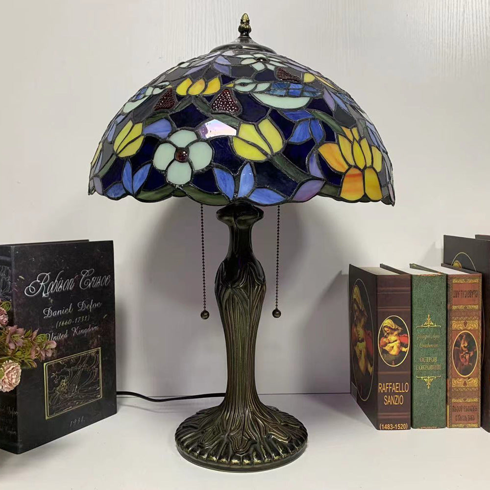 Illuminated stained glass floral lamp on table