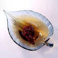 Top view of amber and blue glass leaf bowl with fruit