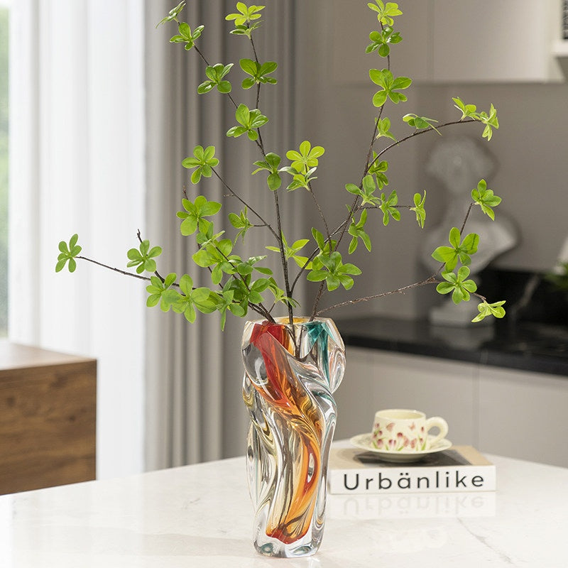 Close up of stained glass twisted vase showing green foliage