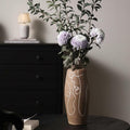 Stoneware abstract line art vase on dark table with flowers