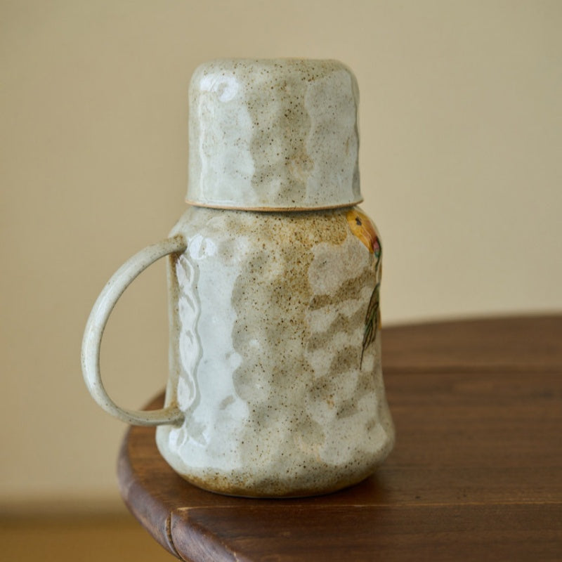 Cup stacked on top of sunflower pitcher
