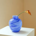 Blue swirled glass vase with single calla lily