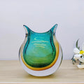 Front view of teal and amber art glass owl shaped vase