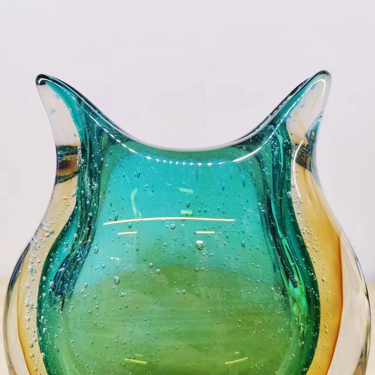 Close up detail of bubble texture and rim on art glass vase