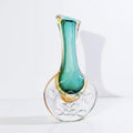 Close up of medium teal and amber vase bubble base