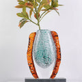 Teal mosaic and amber fluted art glass vase with foliage