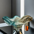 Front view of gradient glass wavy bowl on reflective surface