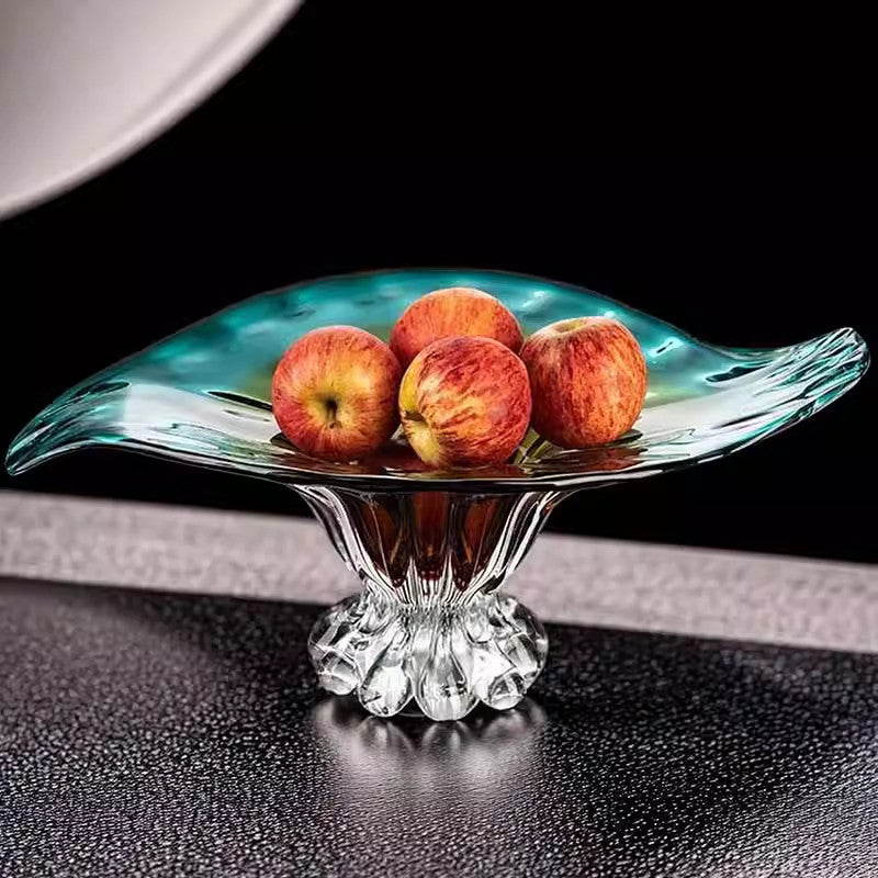 Gradient teal and amber glass bowl holding apples