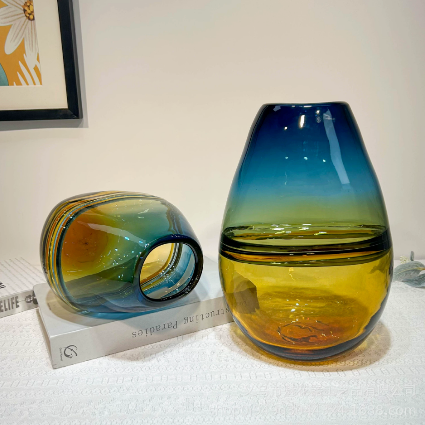 Teal amber glass vase set styled on books as luxury decorative home accents