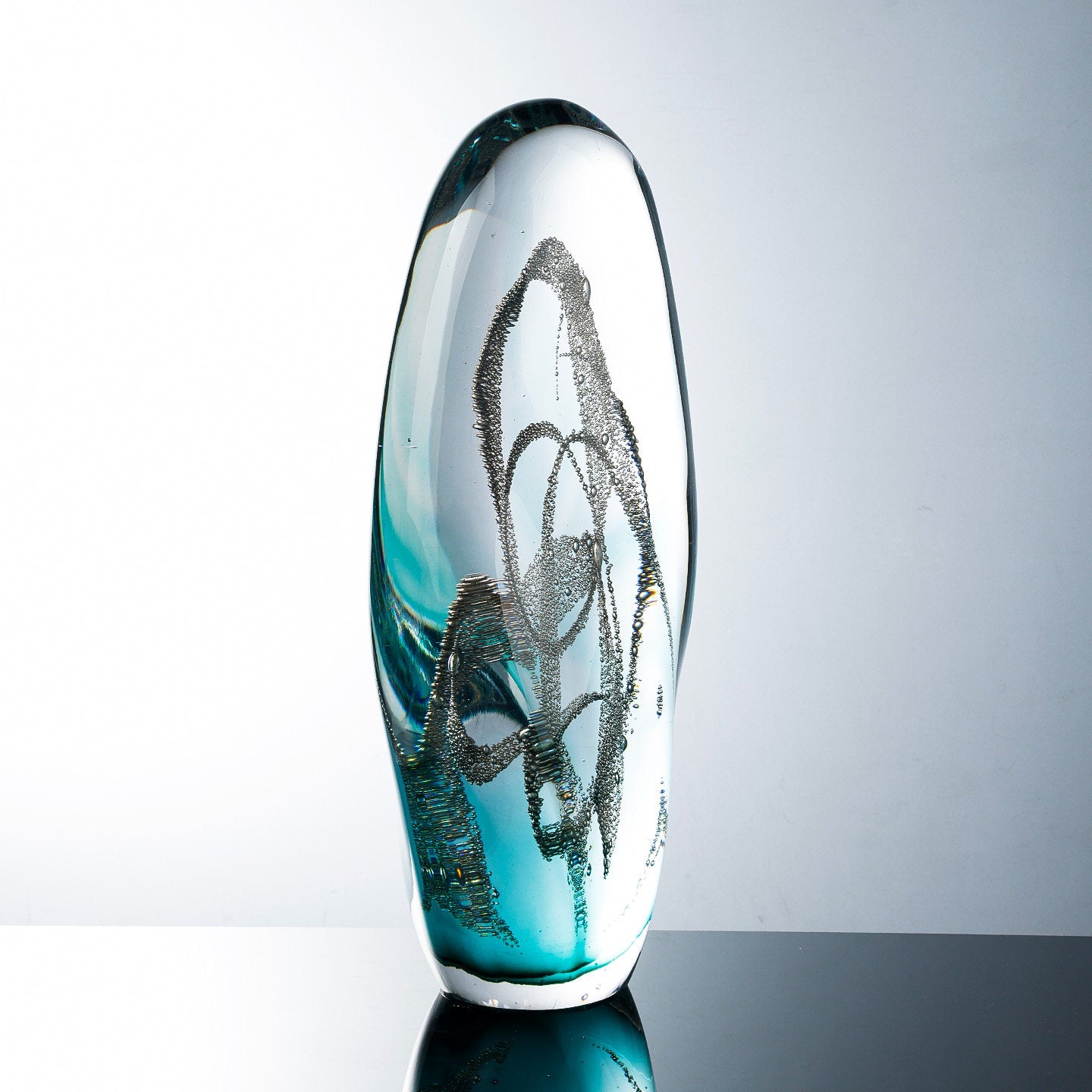 Angled view showing internal bubble patterns and teal gradient