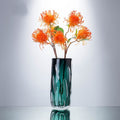 Luxury green vase styled with orange protea flowers