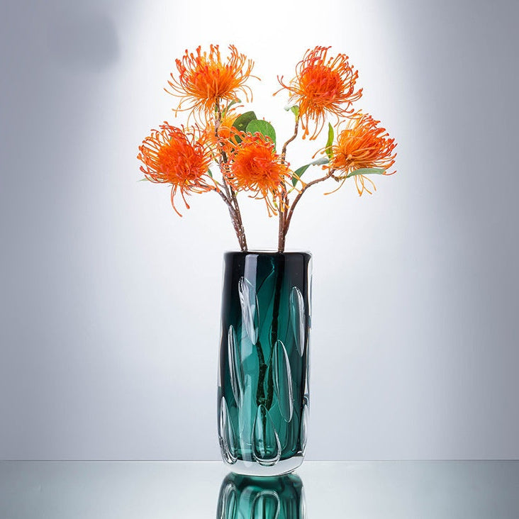 Luxury green vase styled with orange protea flowers