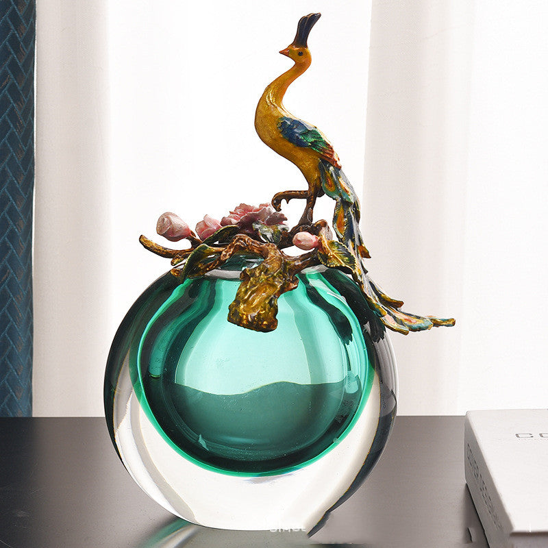 Back view of peacock sculpture vase showing teal glass reservoir