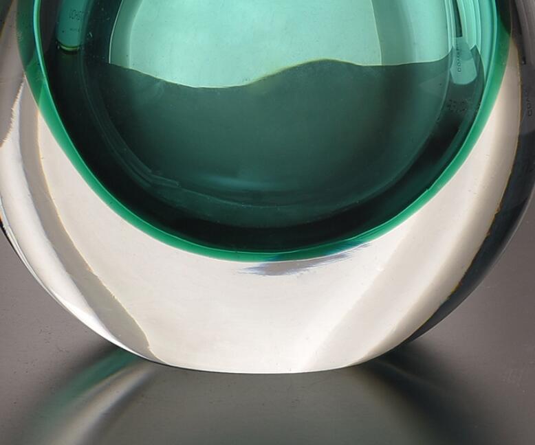 Close up of heavy clear and teal glass base texture