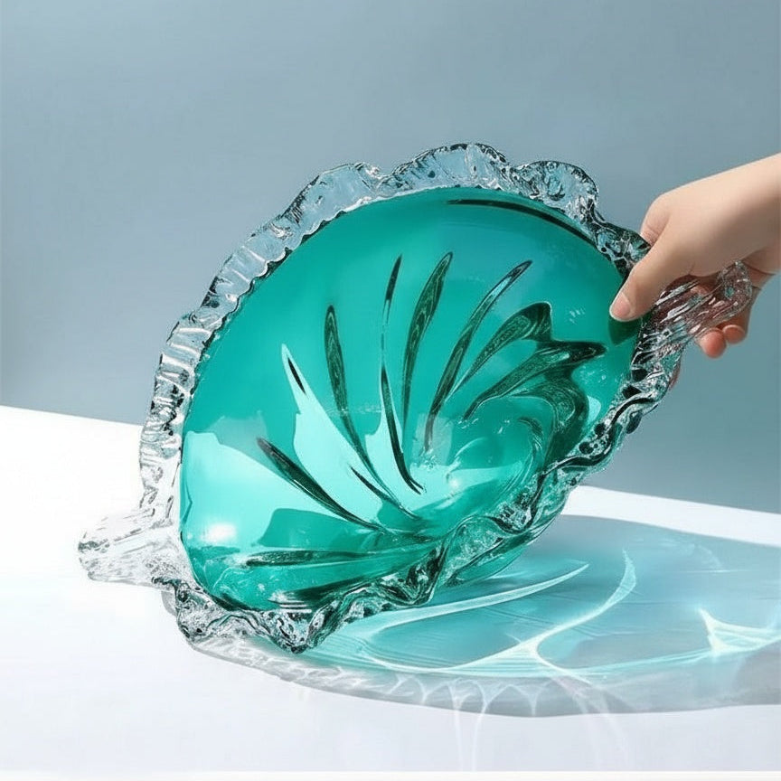 Hand holding large teal glass centerpiece bowl showing scale