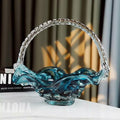 Front view of teal art glass basket centerpiece