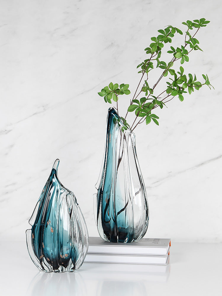 Teal and clear glass vases with organic ribbed design and greenery
