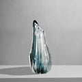 Glass vase with a textured design on a gray background