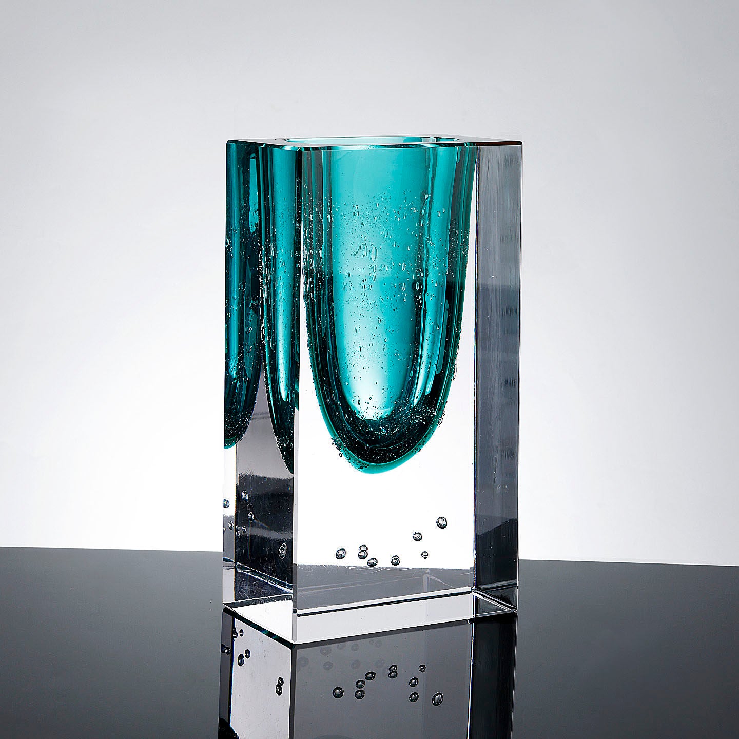 Front view of teal and clear glass block vase