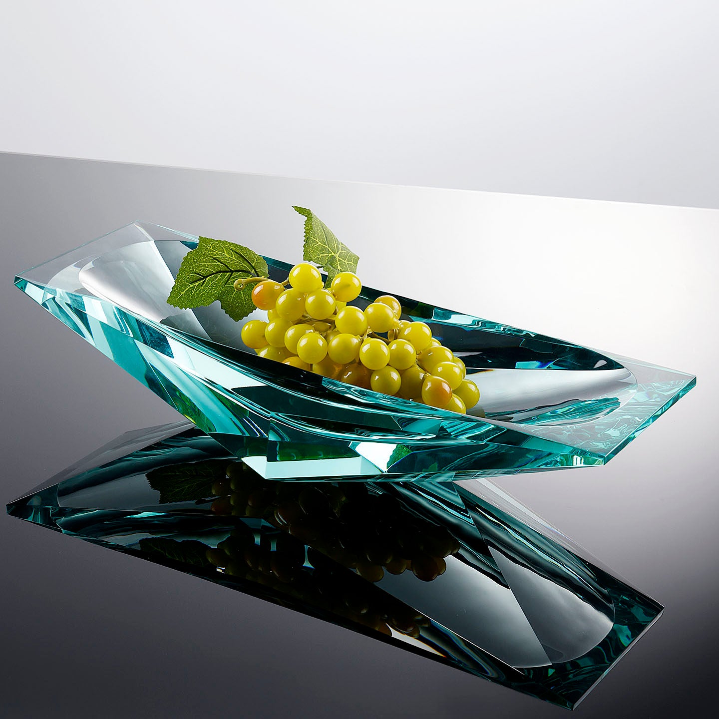 Teal crystal glass geometric centerpiece bowl styled with grapes