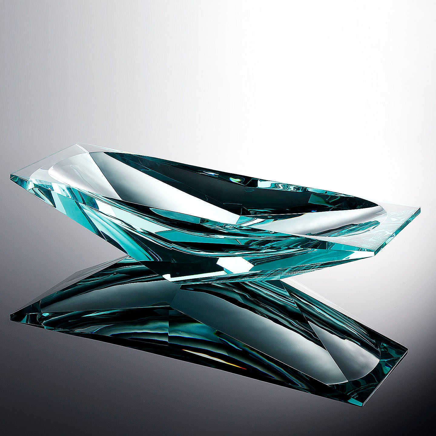 Angled view of empty teal crystal geometric bowl