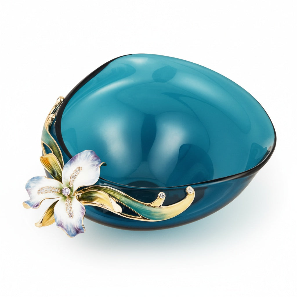 Empty teal glass bowl featuring gold rim and floral detail