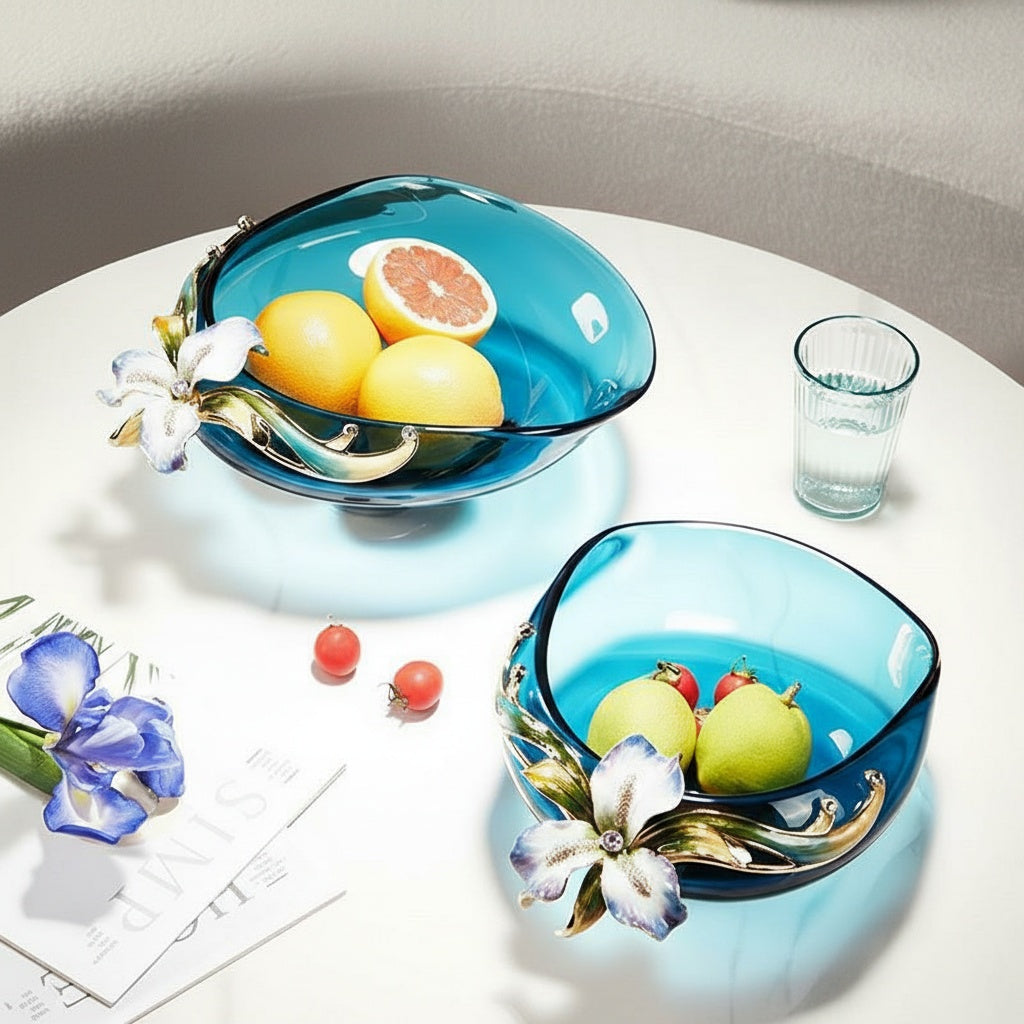 Two teal glass floral bowls displayed on a white table