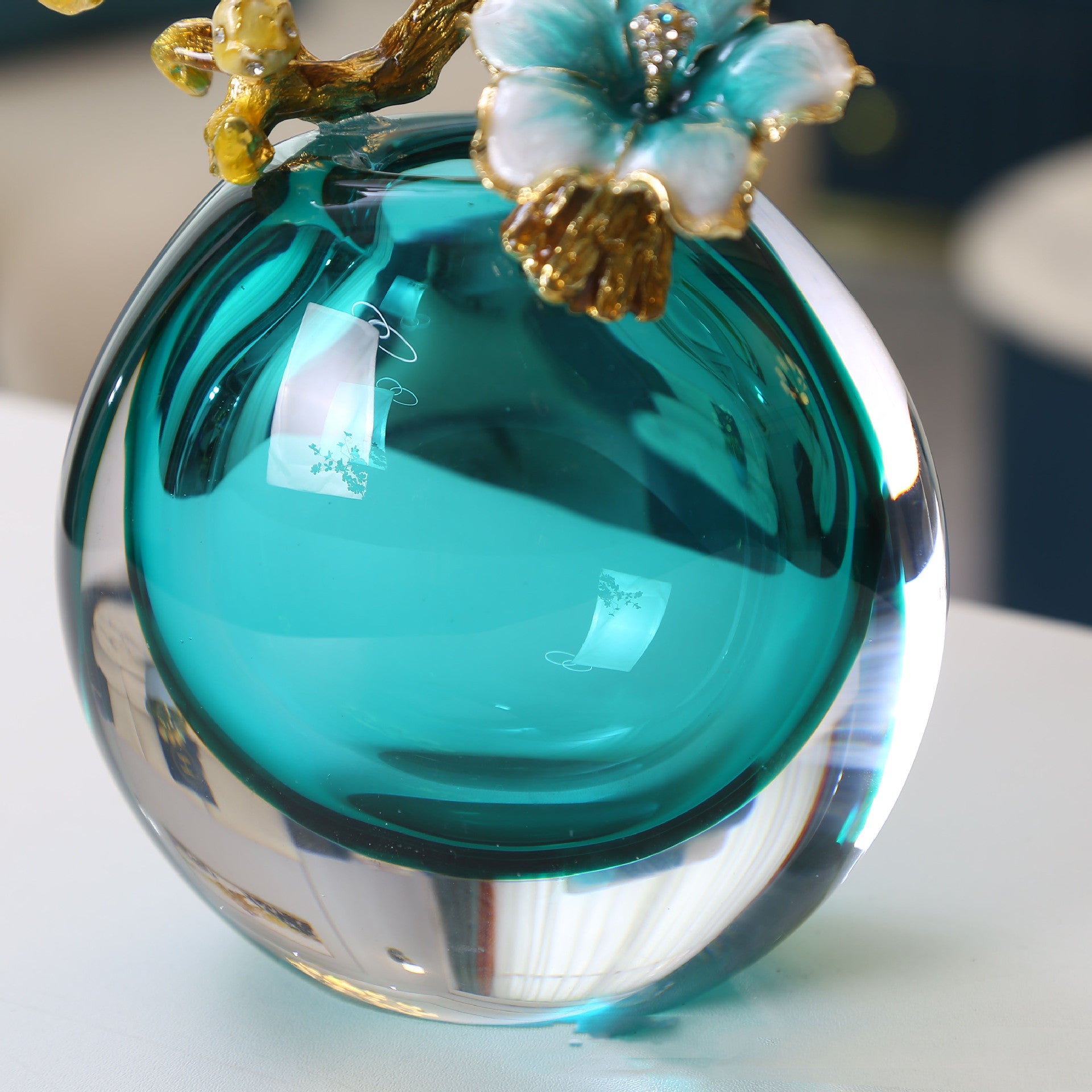 Detail of heavy teal glass clarity and gold metalwork
