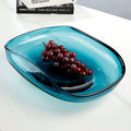 Angled view of teal glass bowl with grapes