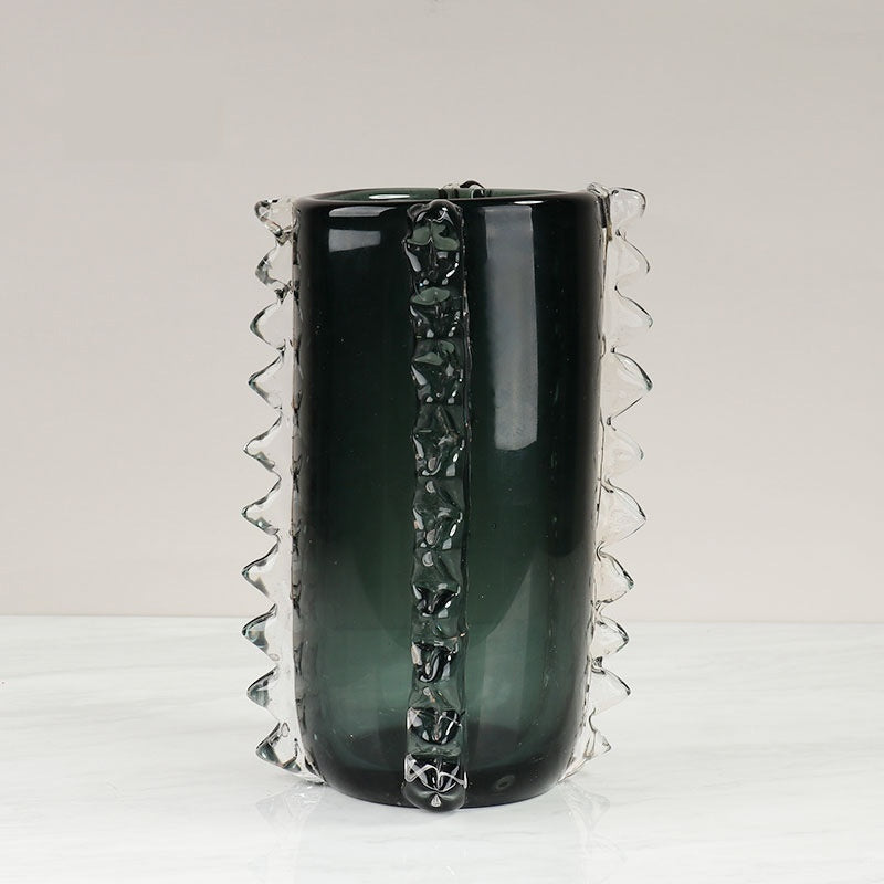 Close up detail of teal glass vase with clear textured fins