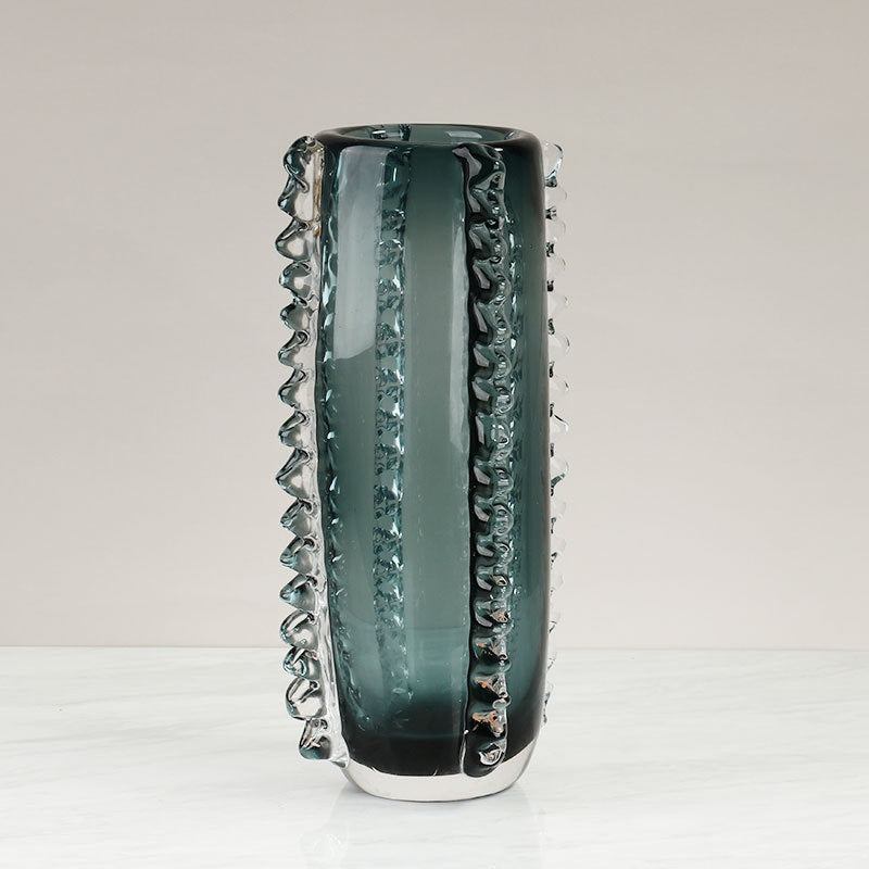 Angled view of teal art glass cylinder vase