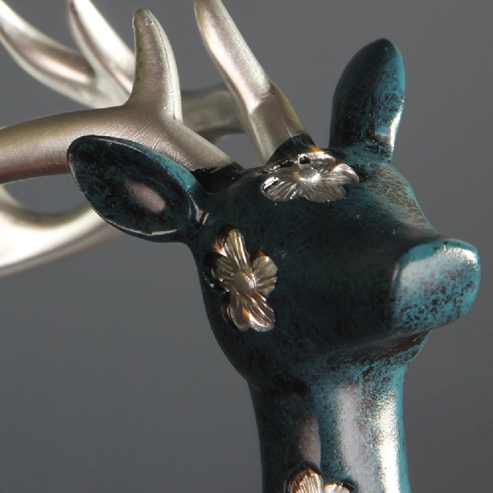 Detail of gold floral pattern on teal deer head