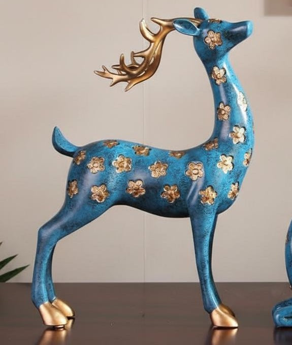 Side view of standing teal and gold floral deer statue