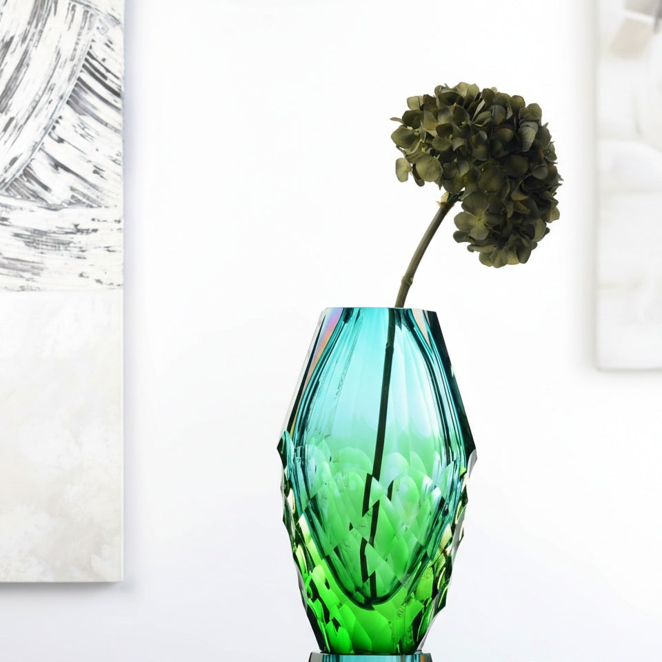 Detail of teal faceted glass vase with light refraction