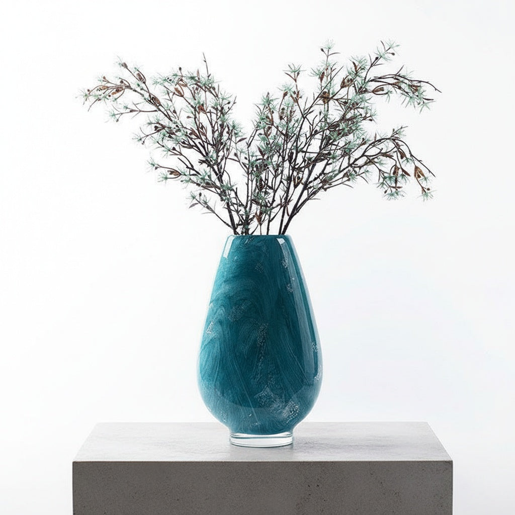 Teal marbled glass teardrop vase with floral arrangement