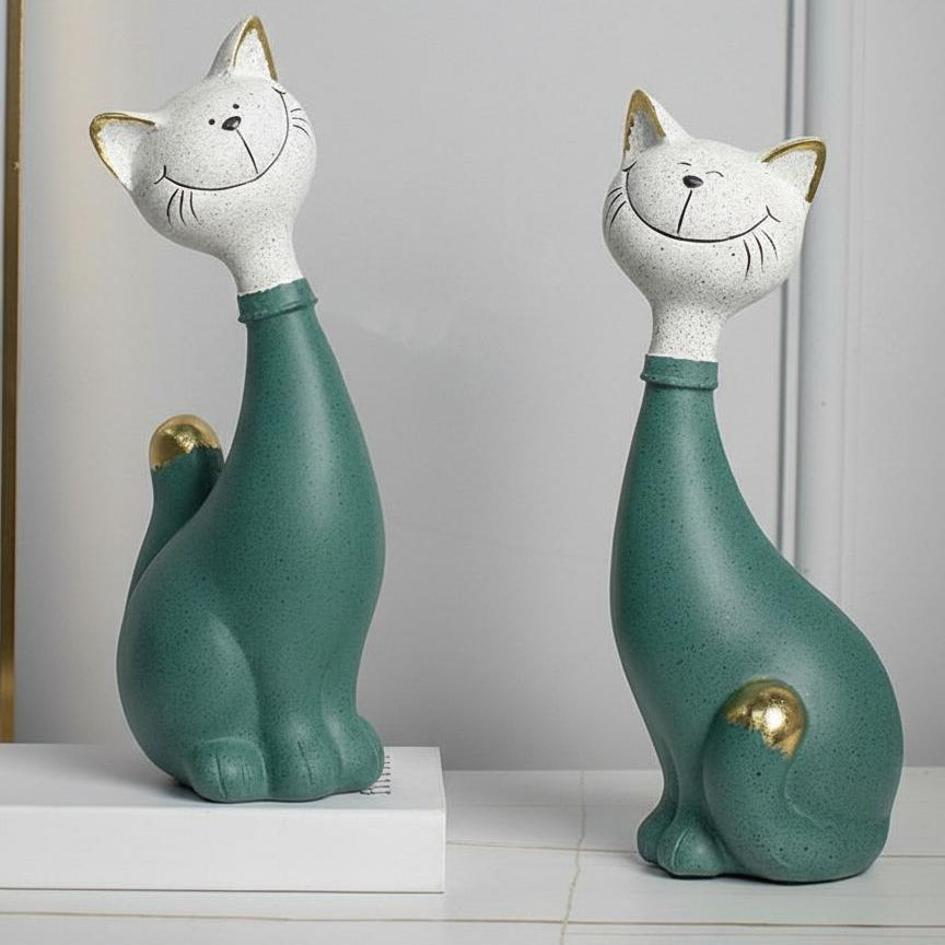 Angled view of stylized teal and white cat figurines