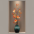 Teal ribbed glass vase with orange magnolia arrangement front view