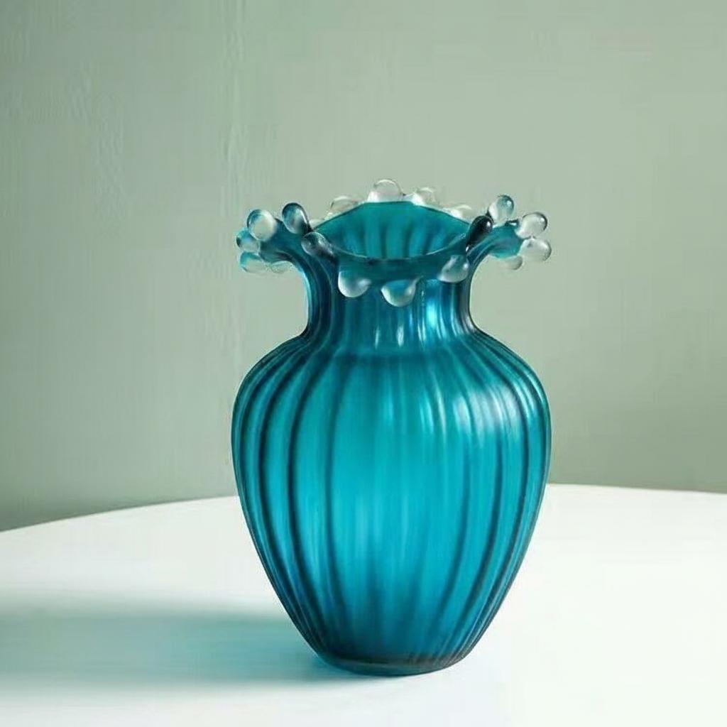 Front view of teal ribbed glass vase