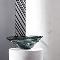 Side view of organic teal seeded glass bowl on pedestal