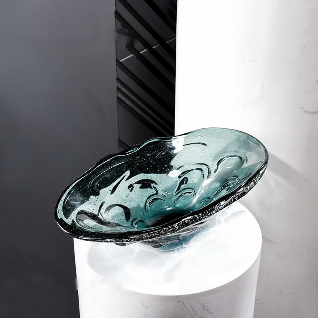 Top angled view showing interior depth and bubble texture of teal glass bowl