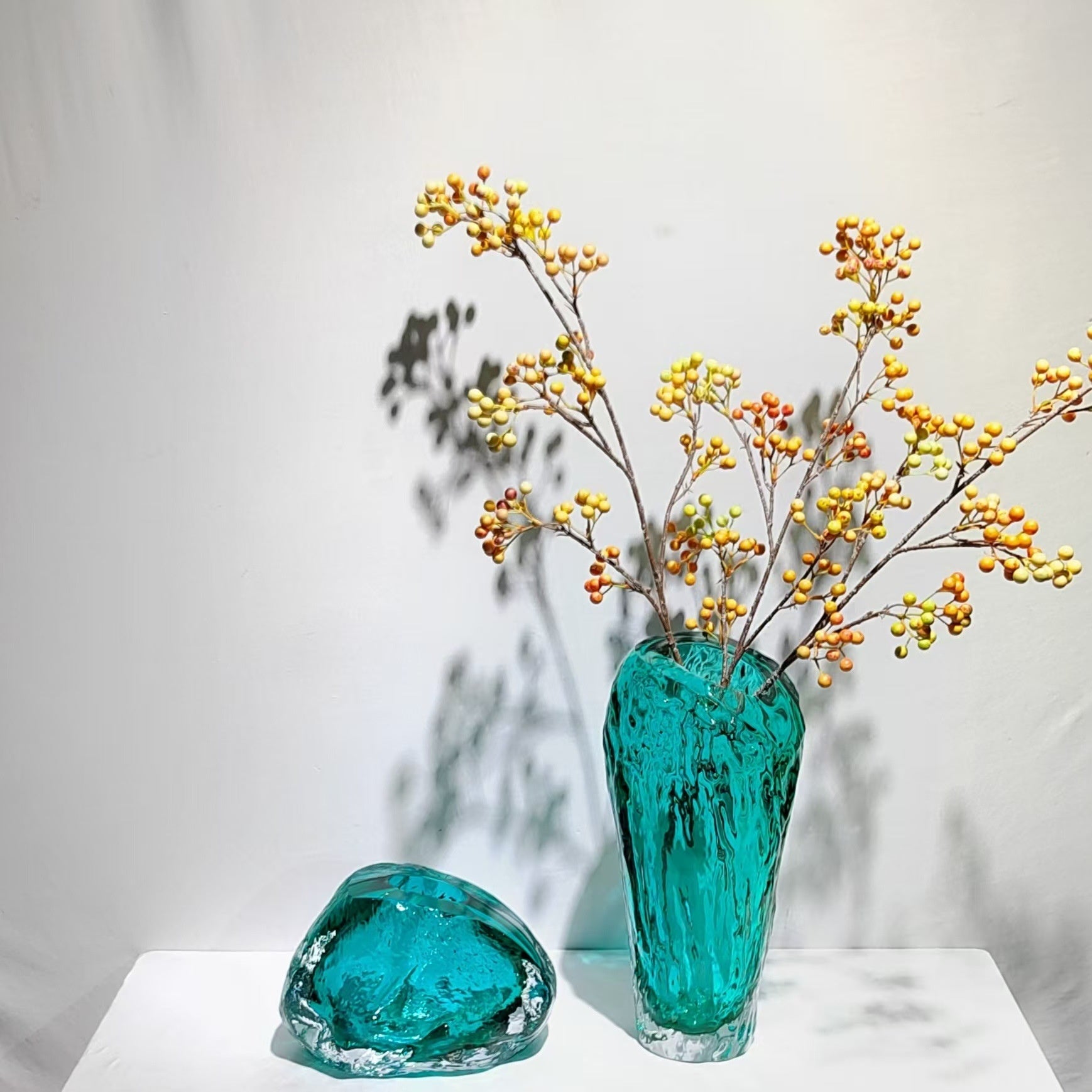 Organic teal glass vases with yellow berries lifestyle