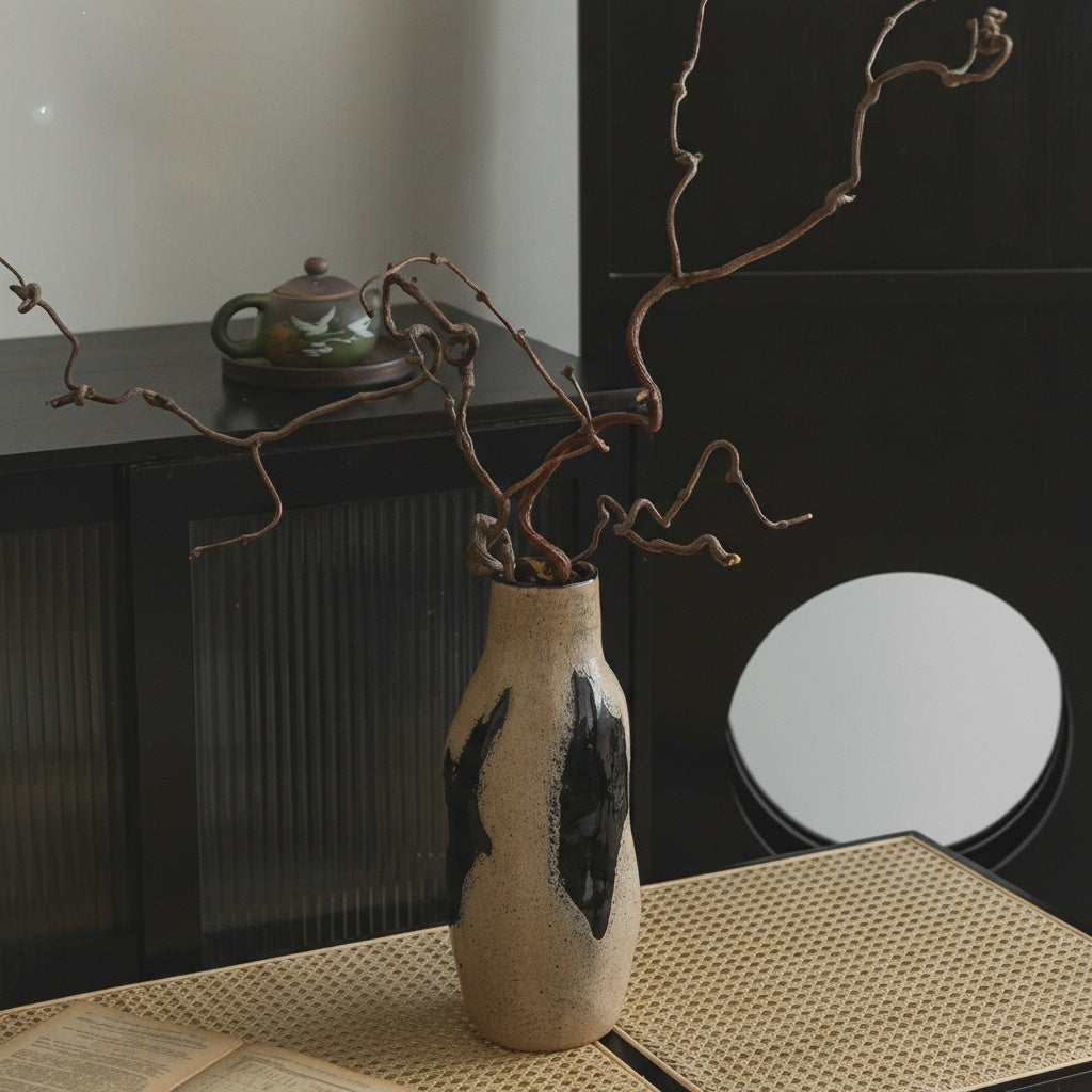 Close up of rustic textured glass vase on rattan surface
