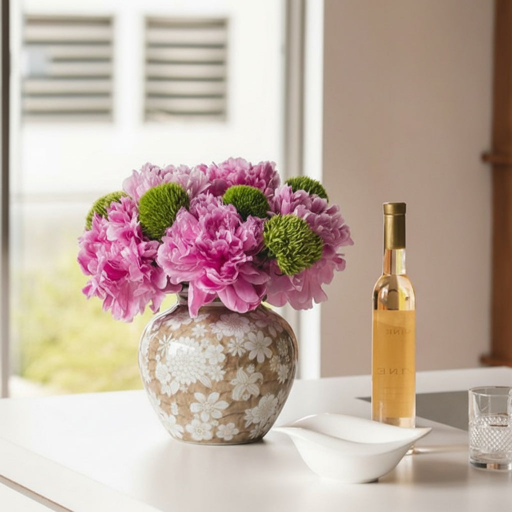 Round ceramic vase with floral pattern on kitchen island