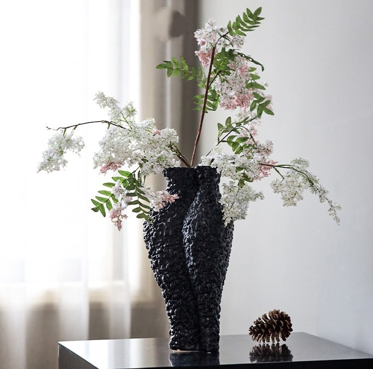 Sculptural black vase styled with white flowers