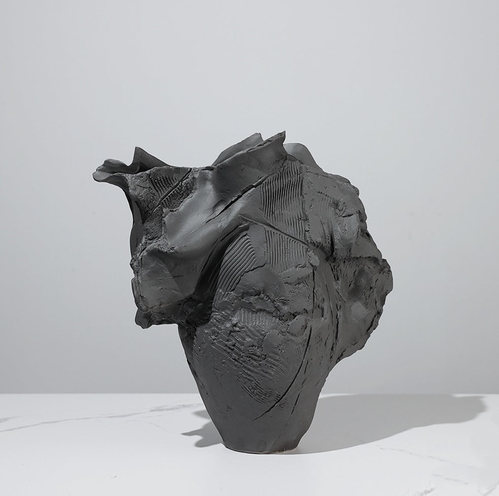 Close up of abstract organic texture on black ceramic vase